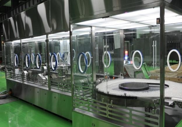 A view of Tofflon's oRABS (Open Restricted Access Barrier System) used in pharmaceutical manufacturing. The system features stainless steel construction with glove ports for sterile operations, ensuring safety and contamination control in cleanroom environments.