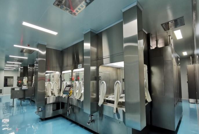 A view of Tofflon's cRABS (Closed Restricted Access Barrier System) designed for sterile pharmaceutical manufacturing. The system features stainless steel enclosures with glove ports for safe, contamination-free handling in cleanroom environments, ensuring high standards of safety and compliance in drug production.
